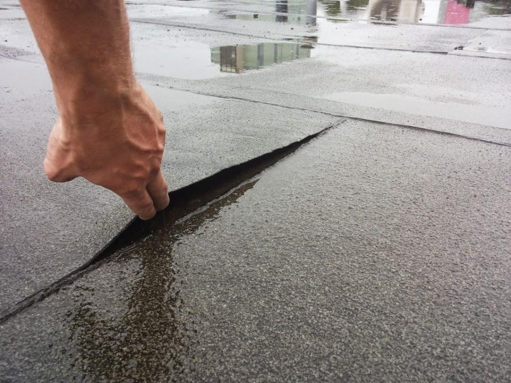 Scheur in plat dak met waterinfiltratie